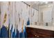 Bathroom with shower/tub combo, granite countertop, and dark brown vanity at 860 Oak Dr, Groveland, FL 34736