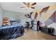 Bedroom with geometric wall art, full-size bed, and mini-fridge at 860 Oak Dr, Groveland, FL 34736