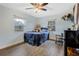 Cozy bedroom with a large bed, ceiling fan, and plenty of natural light at 860 Oak Dr, Groveland, FL 34736