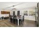 Spacious dining area with a rustic table, chairs, and a barn door at 860 Oak Dr, Groveland, FL 34736