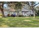 Gray house with white trim, front porch, and large yard at 860 Oak Dr, Groveland, FL 34736