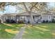 Gray house with white trim, front porch, and large yard at 860 Oak Dr, Groveland, FL 34736