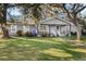 Gray house with white trim, front porch, and large yard at 860 Oak Dr, Groveland, FL 34736