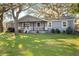 Gray house with white trim, front porch, and large yard at 860 Oak Dr, Groveland, FL 34736
