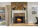 Cozy living room with a stone fireplace and a view of the backyard at 860 Oak Dr, Groveland, FL 34736