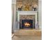 Stone fireplace with a wood-burning fire, creating a warm and inviting atmosphere at 860 Oak Dr, Groveland, FL 34736