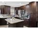 Spacious kitchen with dark cabinets and granite island at 860 Oak Dr, Groveland, FL 34736