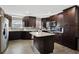 Spacious kitchen with dark cabinets and granite island at 860 Oak Dr, Groveland, FL 34736