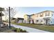 Row of two-story houses with similar design and landscaping at 10876 Waterwood Aly, Orlando, FL 32829