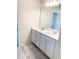 Double vanity bathroom with white cabinets at 10876 Waterwood Aly, Orlando, FL 32829