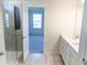 Bathroom with double vanity, shower, and bedroom access at 10876 Waterwood Aly, Orlando, FL 32829