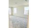 Bright bedroom with neutral carpet and two windows at 10876 Waterwood Aly, Orlando, FL 32829