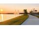 Sunset view of lake with fountain and walking path at 10876 Waterwood Aly, Orlando, FL 32829