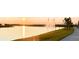 Sunset view of lake with fountain and walking path at 10876 Waterwood Aly, Orlando, FL 32829