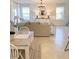 Bright dining area with white table and chairs, near living room at 10876 Waterwood Aly, Orlando, FL 32829