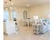 Kitchen and dining area with white cabinets and table, open concept at 10876 Waterwood Aly, Orlando, FL 32829