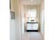 Bright entryway with vintage dresser, rug, and window with roman shade at 10876 Waterwood Aly, Orlando, FL 32829