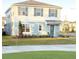 Two-story house with light blue and white siding, landscaping, and a driveway at 10876 Waterwood Aly, Orlando, FL 32829
