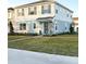 Two-story house with light blue and white siding, landscaping, and a driveway at 10876 Waterwood Aly, Orlando, FL 32829