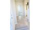 Light-filled hallway with tile floors, access to bedrooms and bath at 10876 Waterwood Aly, Orlando, FL 32829