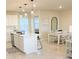 Open concept kitchen with white cabinets, island, and stainless steel appliances at 10876 Waterwood Aly, Orlando, FL 32829