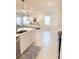Open concept kitchen with white cabinets, island, and stainless steel appliances at 10876 Waterwood Aly, Orlando, FL 32829