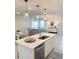 Kitchen island with white cabinets, quartz countertop, and sink at 10876 Waterwood Aly, Orlando, FL 32829