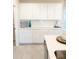 Modern kitchen with white cabinets and a spacious countertop at 10876 Waterwood Aly, Orlando, FL 32829