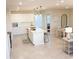 Modern kitchen features white cabinets, a large island, and stainless steel appliances at 10876 Waterwood Aly, Orlando, FL 32829