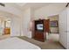 Cozy bedroom featuring a television cabinet, plush carpet, and a doorway to the bathroom at 1310 Seven Eagles Ct # 301, Reunion, FL 34747