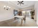 Bright dining room with chandelier and access to balcony at 1310 Seven Eagles Ct # 301, Reunion, FL 34747