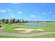 Peaceful golf course with lake and houses in the background at 1310 Seven Eagles Ct # 301, Reunion, FL 34747