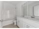 Modern bathroom with double vanity and tile shower/tub combo at 1365 Hanoverian Dr, Lake Alfred, FL 33850
