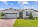 Gray house with a two-car garage and a landscaped front yard at 1365 Hanoverian Dr, Lake Alfred, FL 33850