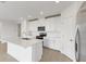 Modern kitchen with white cabinets, stainless steel appliances, and an island at 1365 Hanoverian Dr, Lake Alfred, FL 33850