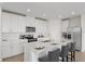 Modern kitchen with white cabinets, stainless steel appliances, and an island at 1365 Hanoverian Dr, Lake Alfred, FL 33850