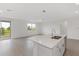 Open concept kitchen and living room with tile floors and sliding glass doors at 1365 Hanoverian Dr, Lake Alfred, FL 33850