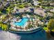 Aerial view of community pool and clubhouse with surrounding landscape at 1402 Lisbon Ct, Davenport, FL 33896