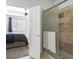 Bathroom with a shower, tiled walls, and white towels at 1402 Lisbon Ct, Davenport, FL 33896