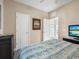 Guest bedroom with TV and ample closet space at 1402 Lisbon Ct, Davenport, FL 33896