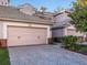 Pink garage doors and brick paver driveway at 1402 Lisbon Ct, Davenport, FL 33896
