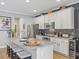 Modern kitchen with white cabinets, granite island, and wine cooler at 1402 Lisbon Ct, Davenport, FL 33896