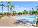 Resort-style pool with lounge chairs and palm trees at 1402 Lisbon Ct, Davenport, FL 33896