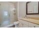 Modern bathroom with a walk-in shower, granite countertop, and white cabinets at 142 Southern Pecan Cir # 207, Winter Garden, FL 34787