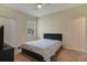 Simple bedroom with light-beige walls, carpet, and a queen bed at 142 Southern Pecan Cir # 207, Winter Garden, FL 34787