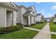 Exterior view of townhome with manicured landscaping and walkway at 142 Southern Pecan Cir # 207, Winter Garden, FL 34787