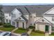 Two-story townhouses with gray roofs, light-colored siding, and landscaping at 142 Southern Pecan Cir # 207, Winter Garden, FL 34787