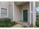 Green front door with landscaping and walkway at 142 Southern Pecan Cir # 207, Winter Garden, FL 34787
