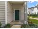 Green front door entry to a tan-colored townhouse at 142 Southern Pecan Cir # 207, Winter Garden, FL 34787