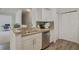 Kitchen with double sink, granite countertops, and white cabinets at 142 Southern Pecan Cir # 207, Winter Garden, FL 34787